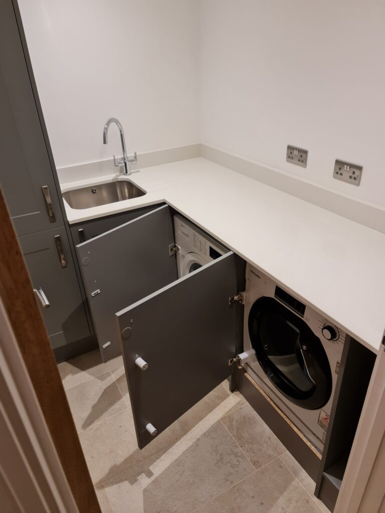 Gallery of completed projects. Integrated washing machine and tumble dryer in utility room